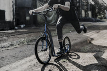 Adult man riding blue Yedoo S2016 scooter kick bike