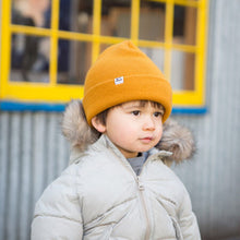 Little child with Harvest yellow kids beanie hat, toque