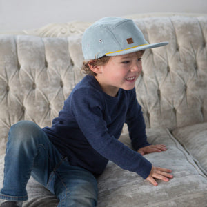 Kid with blue corduroy 5 panel kids hat by XS Unified