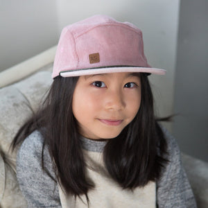 Kid with pink corduroy 5 panel kids hat by XS Unified