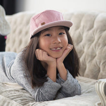 Kid with pink corduroy 5 panel kids hat by XS Unified